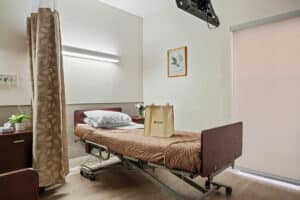 A semi-private room at the Kennedy Care facility with windows